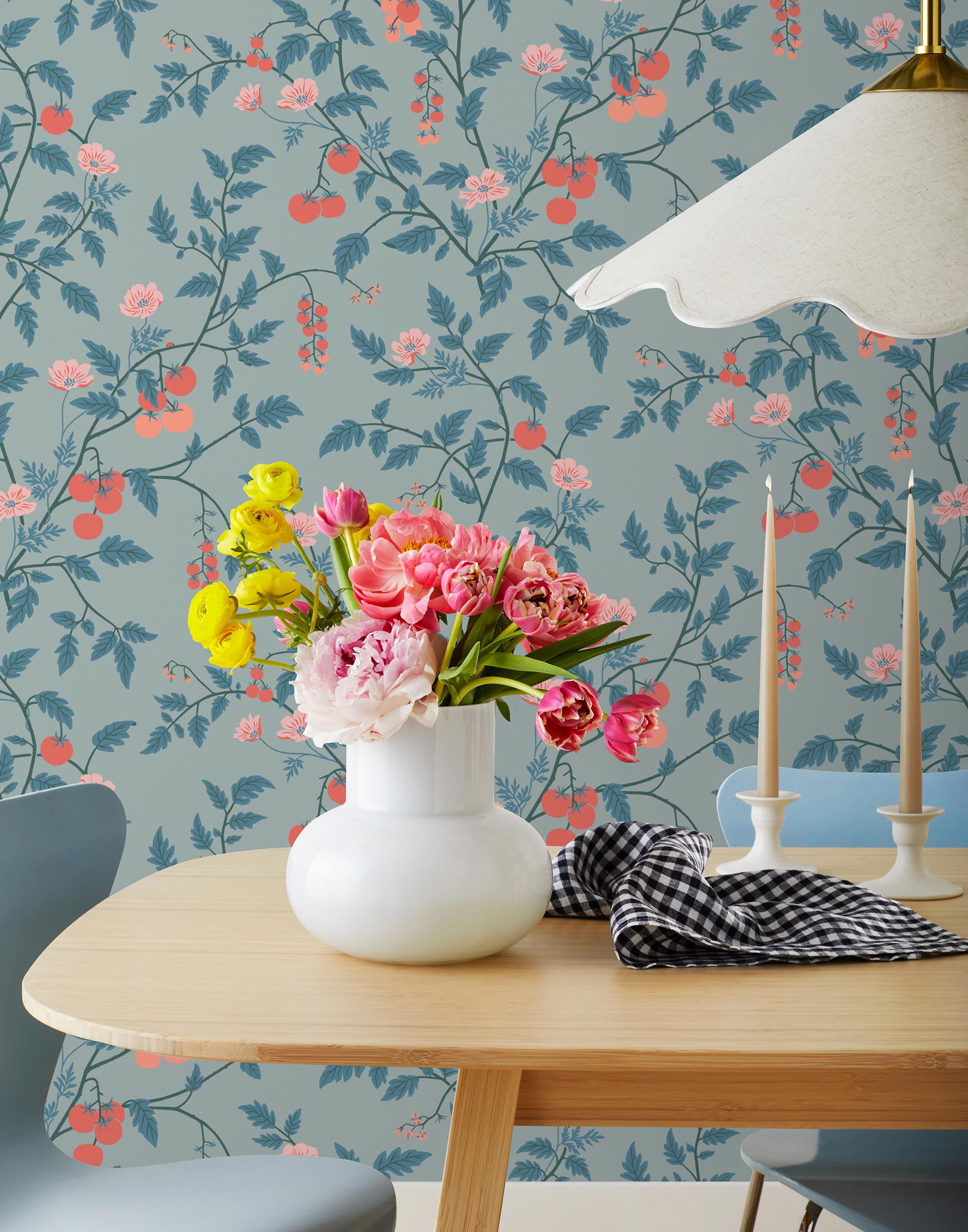 Our Heirloom wallpaper celebrates the annual arrival of tomato season. Highly durable, fade resistant, and made in the USA. This wallpaper features red and peach tomatoes, pink flowers and blue vines on a light blue background and was created in collaboration with The Aesthetics of Joy.