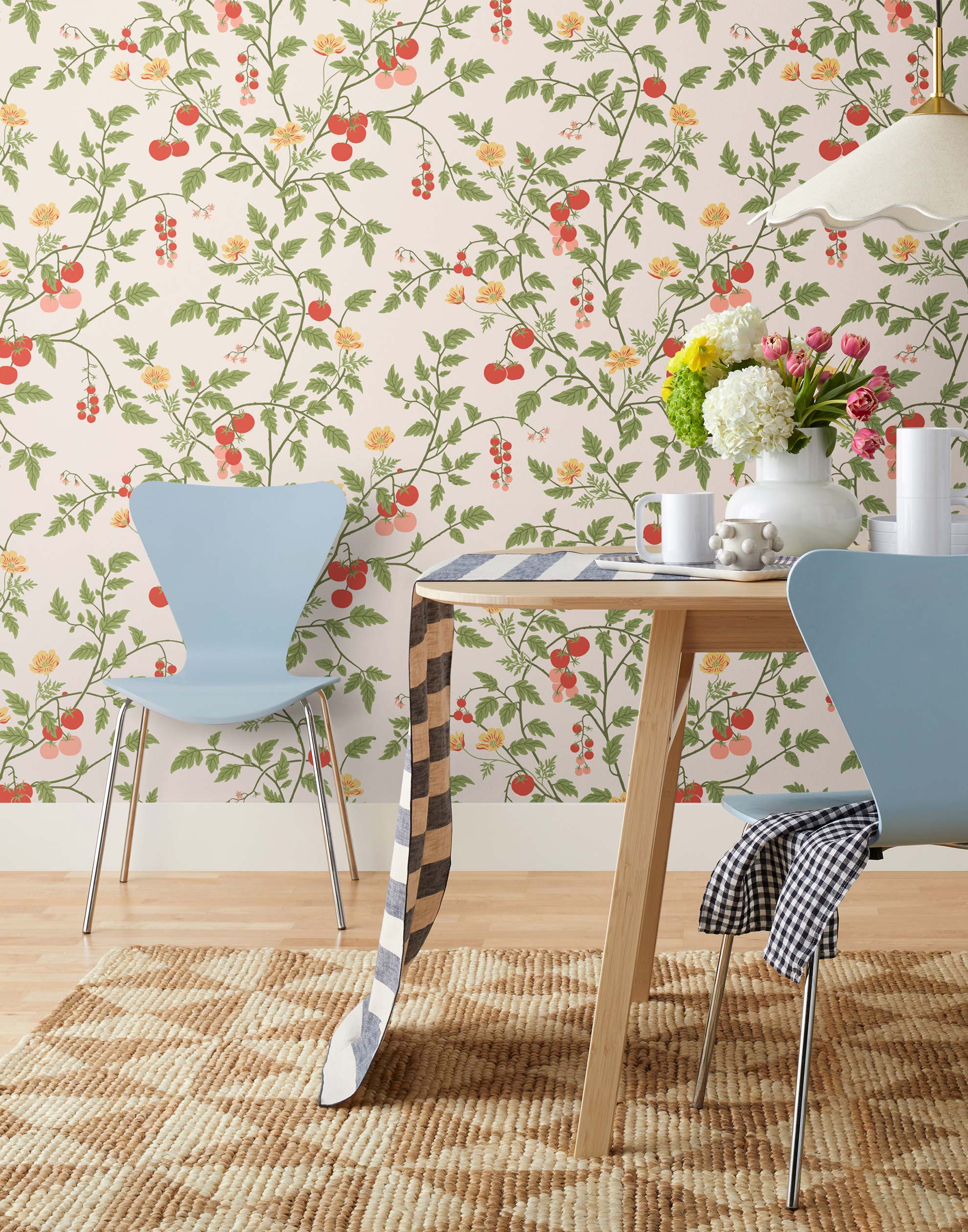 Our Heirloom wallpaper celebrates the annual arrival of tomato season. Highly durable, fade resistant, and made in the USA. This wallpaper features red and pink tomatoes, yellow flowers and green vines on a pink background and was created in collaboration with The Aesthetics of Joy.