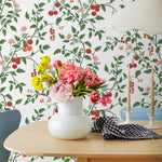Our Heirloom wallpaper celebrates the annual arrival of tomato season. Highly durable, fade resistant, and made in the USA. This wallpaper features red and orange tomatoes, pink flowers and green vines on a white background and was created in collaboration with The Aesthetics of Joy.