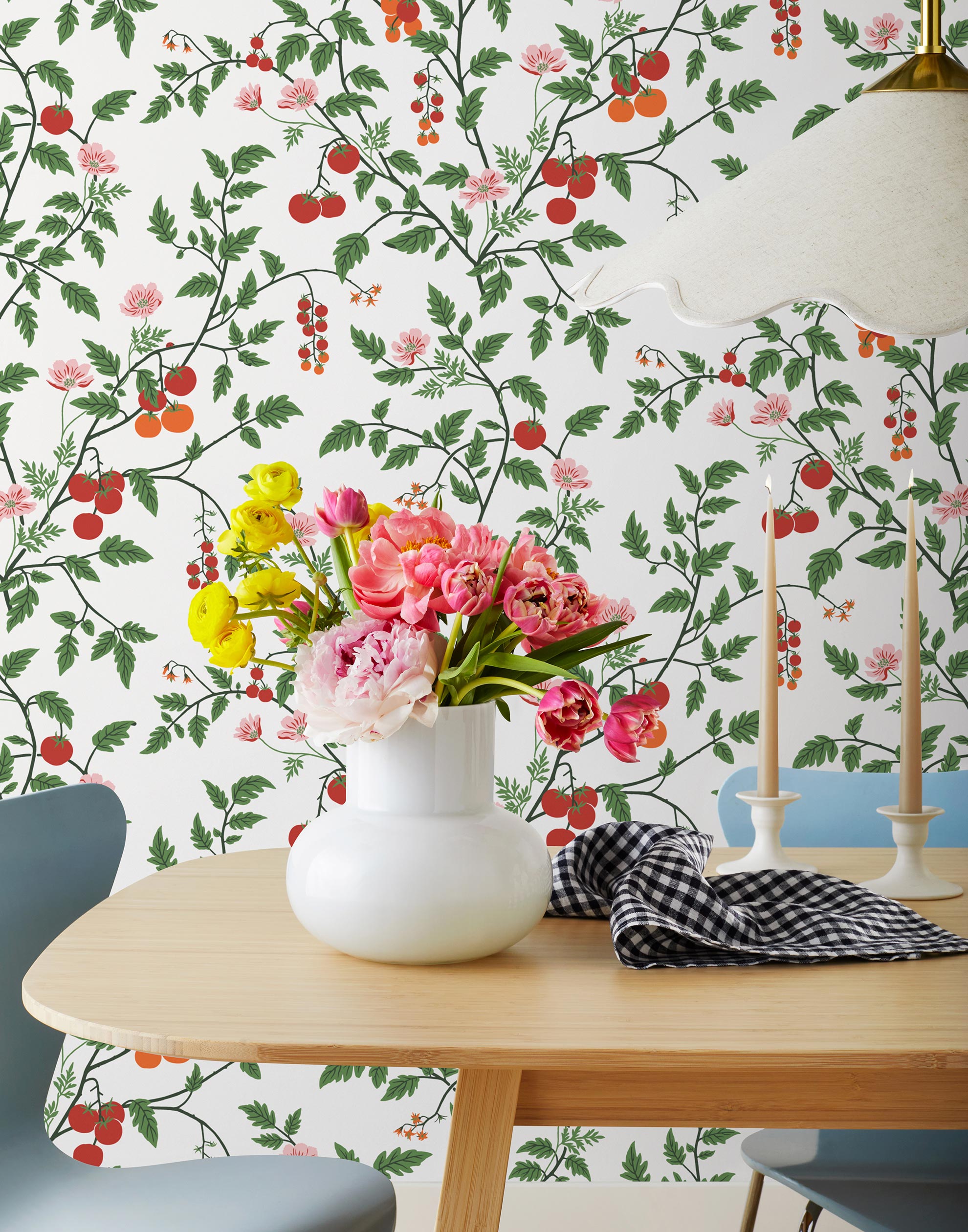 Our Heirloom wallpaper celebrates the annual arrival of tomato season. Highly durable, fade resistant, and made in the USA. This wallpaper features red and orange tomatoes, pink flowers and green vines on a white background and was created in collaboration with The Aesthetics of Joy.
