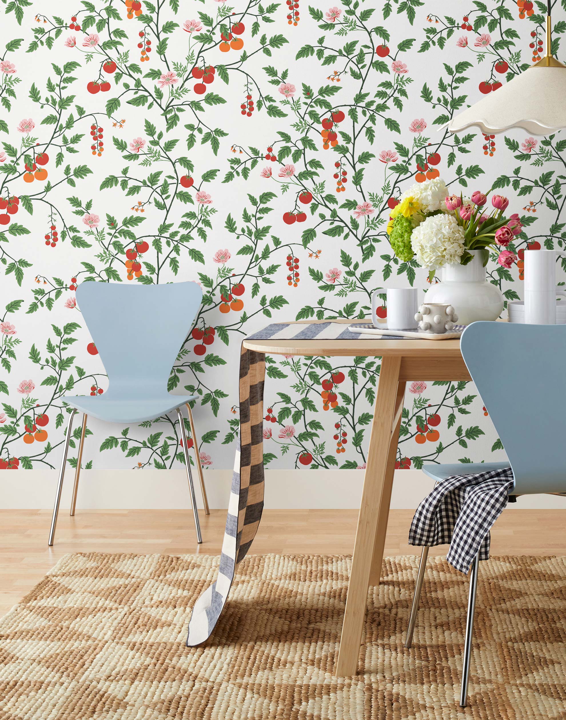 Our Heirloom wallpaper celebrates the annual arrival of tomato season. Highly durable, fade resistant, and made in the USA. This wallpaper features red and orange tomatoes, pink flowers and green vines on a white background and was created in collaboration with The Aesthetics of Joy.