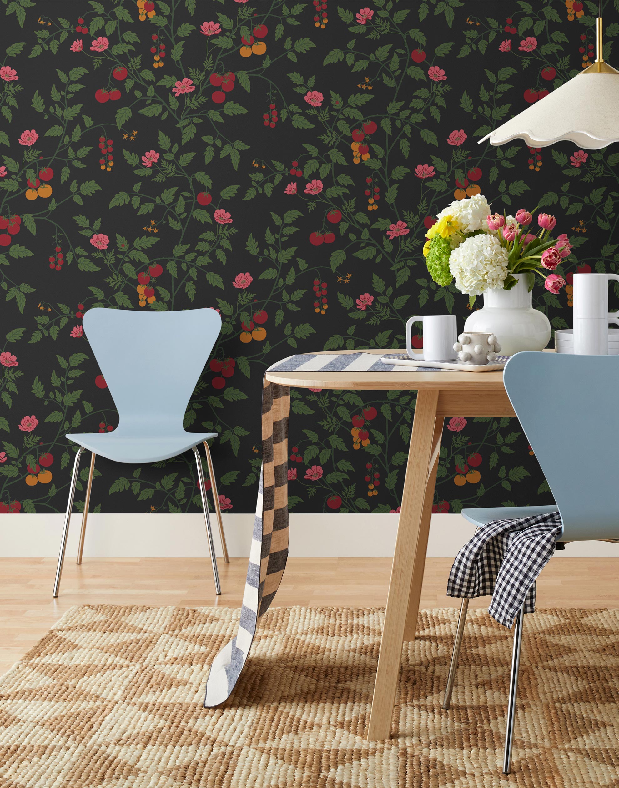 Our Heirloom wallpaper celebrates the annual arrival of tomato season. Highly durable, fade resistant, and made in the USA. This wallpaper features red and orange tomatoes, pink flowers and green vines on a black background and was created in collaboration with The Aesthetics of Joy.