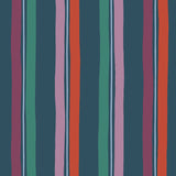 Our Picnic wallpaper was inspired by the wavy stripes of a picnic blanket. Highly durable, fade resistant, and made in the USA. This wallpaper has red, purple, lilac and green stripes on a navy blue background and was made in collaboration with The Aesthetics of Joy.