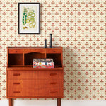 Zinnia (Parchment) Wallpaper mixes a geometric layout with the soft details of the zinnia flower. Pink, red and green illustration on a cream ground.
