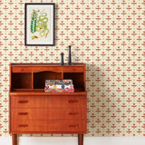 Zinnia (Parchment) Wallpaper mixes a geometric layout with the soft details of the zinnia flower. Pink, red and green illustration on a cream ground.