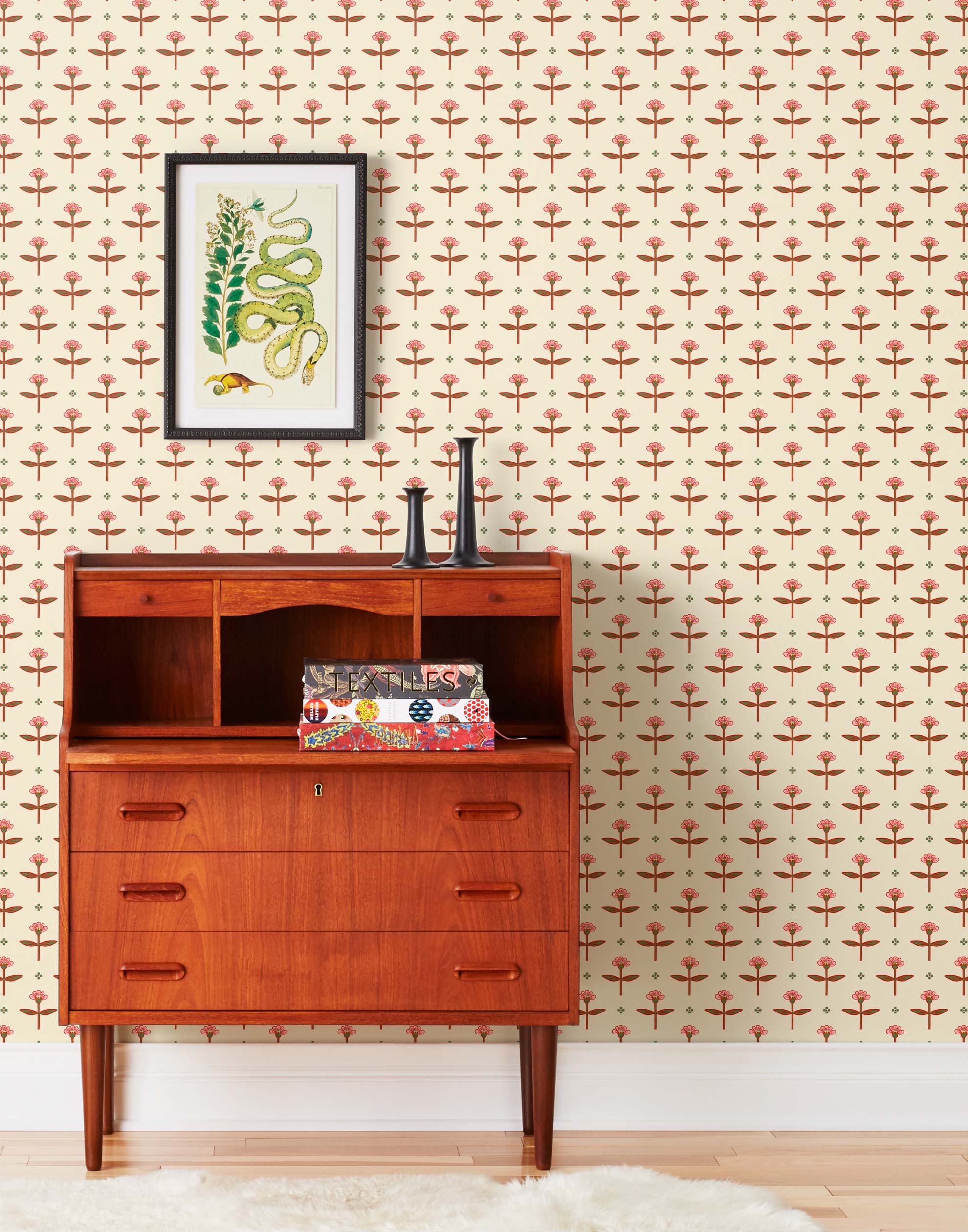 Zinnia (Parchment) Wallpaper mixes a geometric layout with the soft details of the zinnia flower. Pink, red and green illustration on a cream ground.