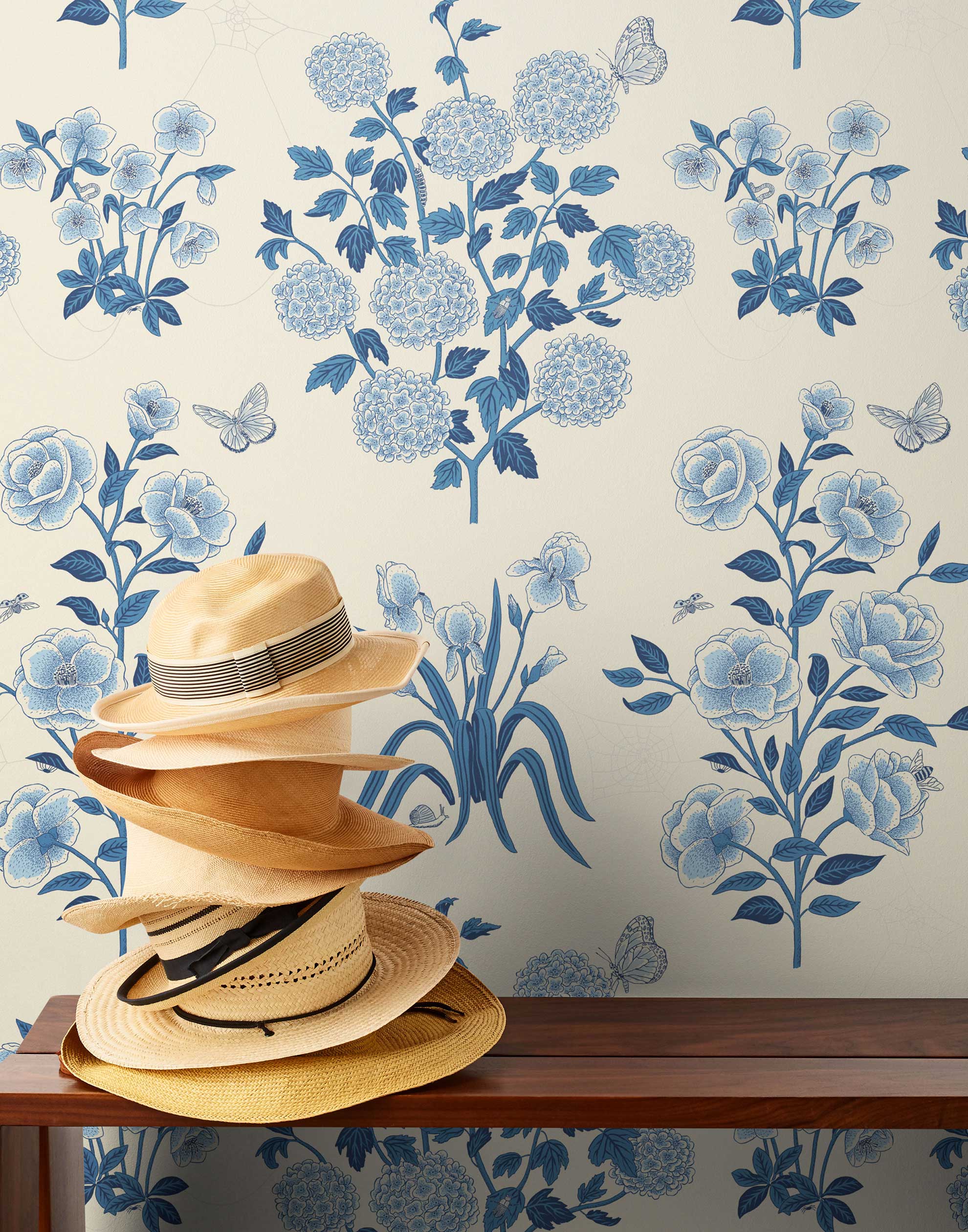 This large-scale wallpaper features hand drawn bees, butterflies and other garden friends frolic among flowers - camellias, hellebores, irises, and snowball trees. Harmony (Porcelain) is printed in shades of blue on a cream background.