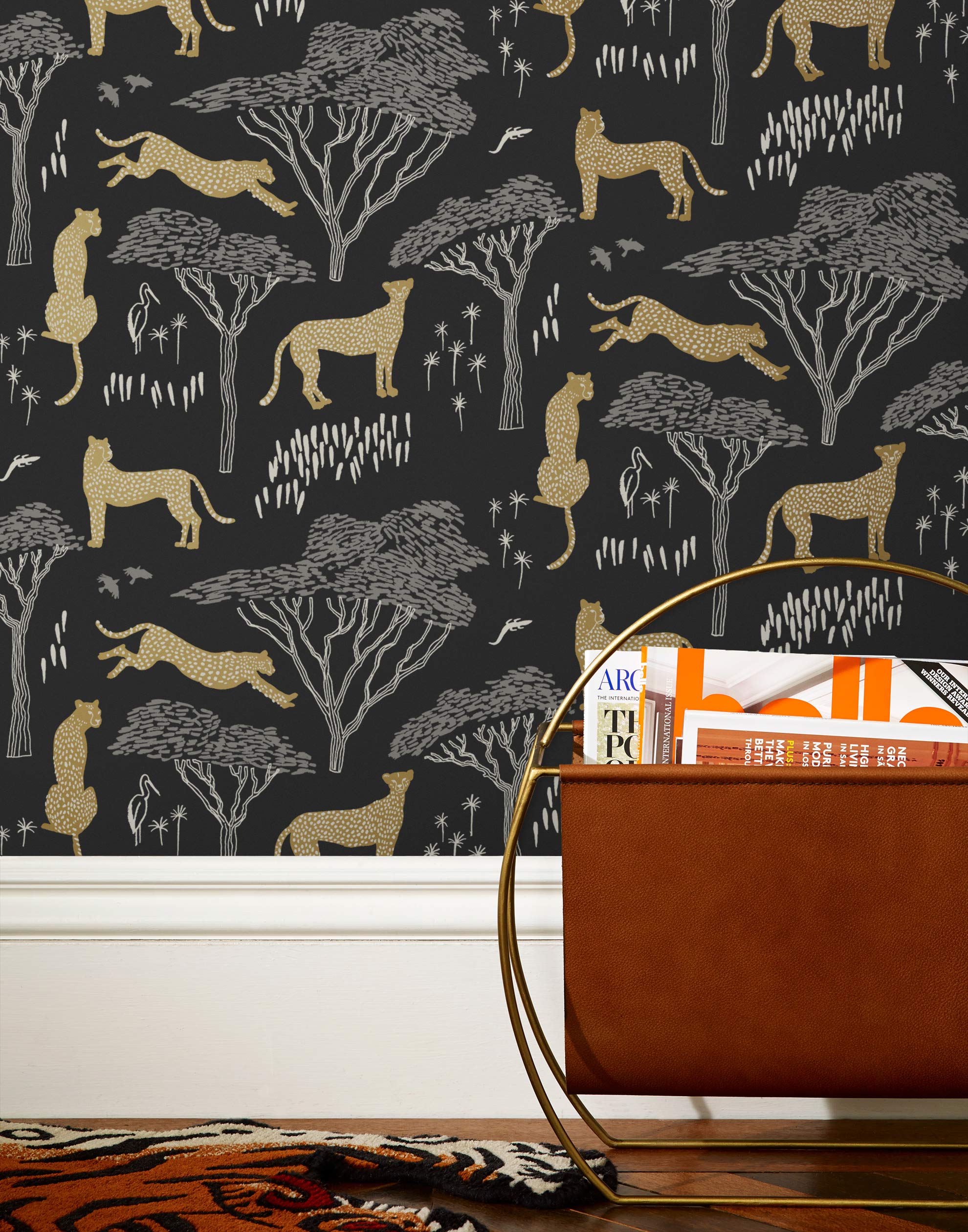 Our Serengeti wallpaper features gold cheetahs and gray birds scattered among gray acacia trees on a black background, reflecting the powerful beauty of the vast plains. Designed by Julia Rothman and made in the USA.