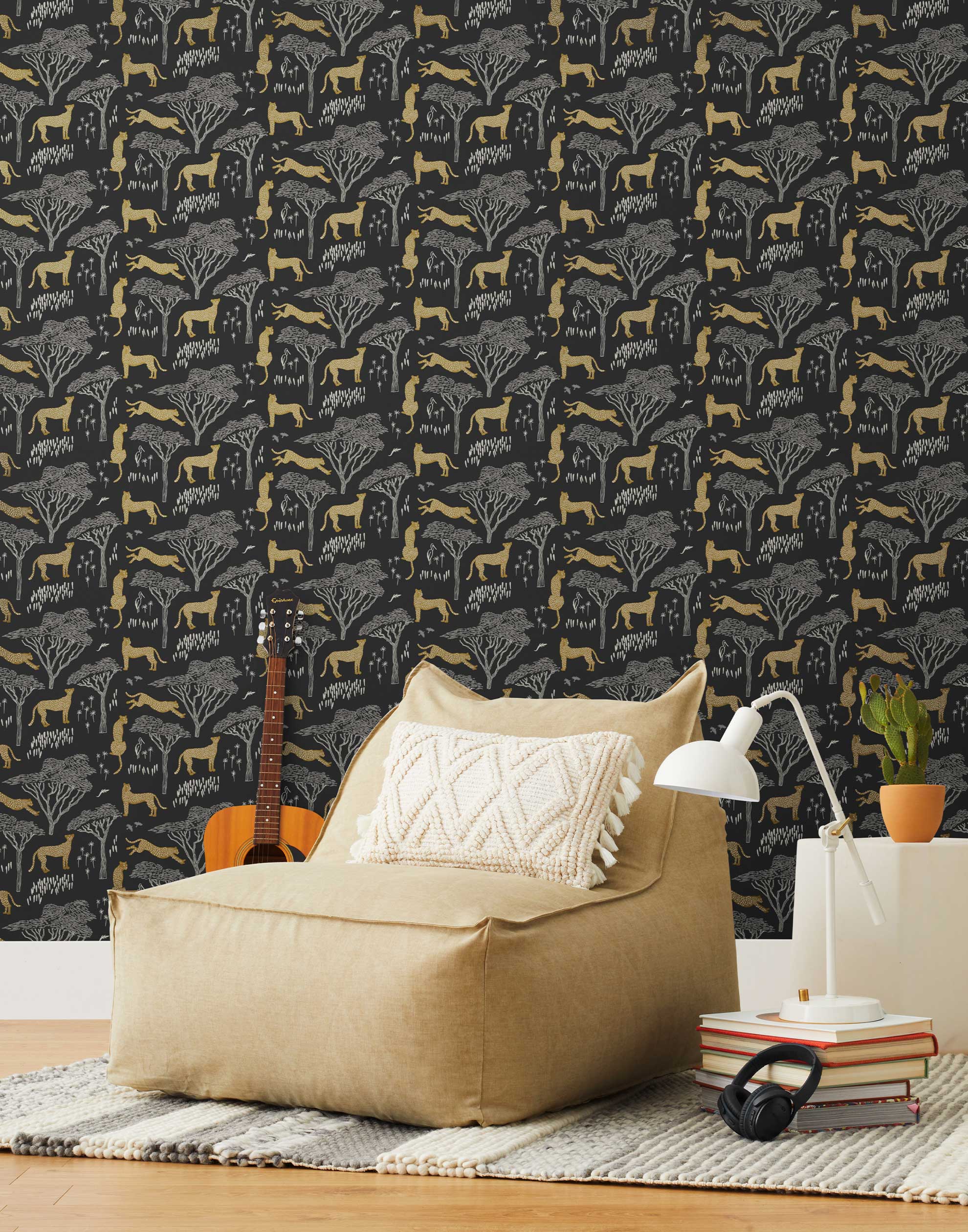 Our Serengeti wallpaper features gold cheetahs and gray birds scattered among gray acacia trees on a black background, reflecting the powerful beauty of the vast plains. Designed by Julia Rothman and made in the USA.