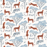 Our Serengeti wallpaper features orange cheetahs and navy birds scattered among blue acacia trees on a white background, reflecting the powerful beauty of the vast plains. Designed by Julia Rothman and made in the USA.