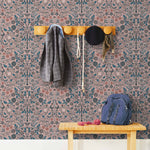Nora (Rose) wallpaper features a garden of bees, birds, strawberries, and flowers in blue, pink, and white on a dusty pink background.