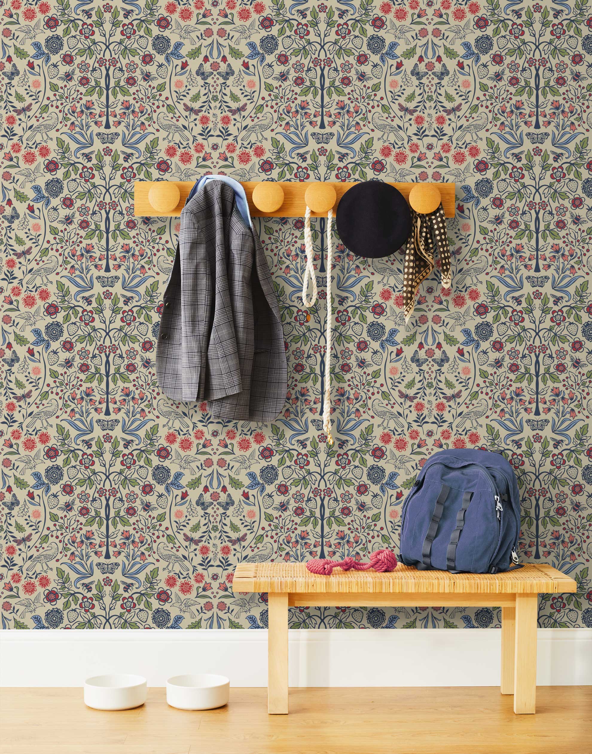 Nora (Taupe) wallpaper features a garden of bees, birds, strawberries, and flowers in shades of blue, pink, and white on a cream background.