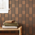 Wallpaper with undulating copper lines that form rhythmic columns on a dark gray background | Schoolhouse + Hygge & West