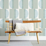 Wallpaper with irregular line work that weaves greenr rectangles and blue semicircles on a white background | Before and after