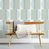 Wallpaper with irregular line work that weaves greenr rectangles and blue semicircles on a white background | Before and after