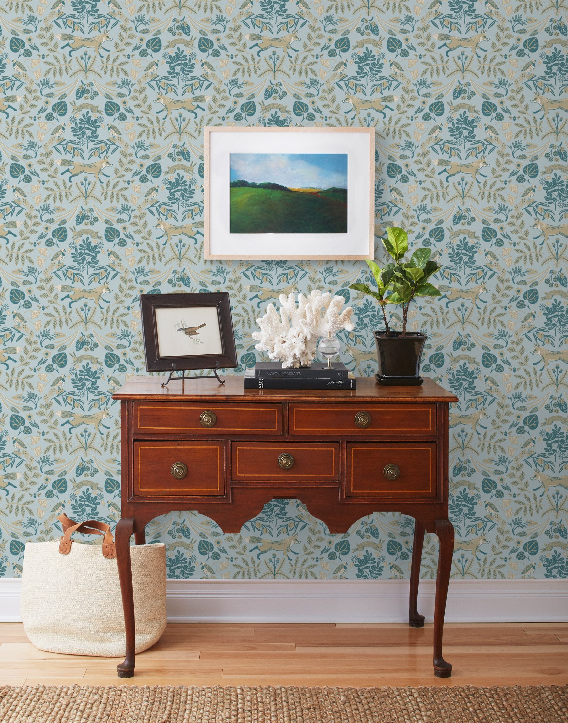 Piedmont (Mist) wallpaper with tan foxes, dusty deep green flora, cream accents on a light gray blue background