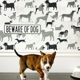 Dog Park (Gray) wallpaper featuring illustrated dogs in shades of gray on white designed by Julia Rothman