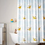 Daydream (Sunshine) Shower Curtain features a pattern of flying birds and floating clouds in yellow and blue on white