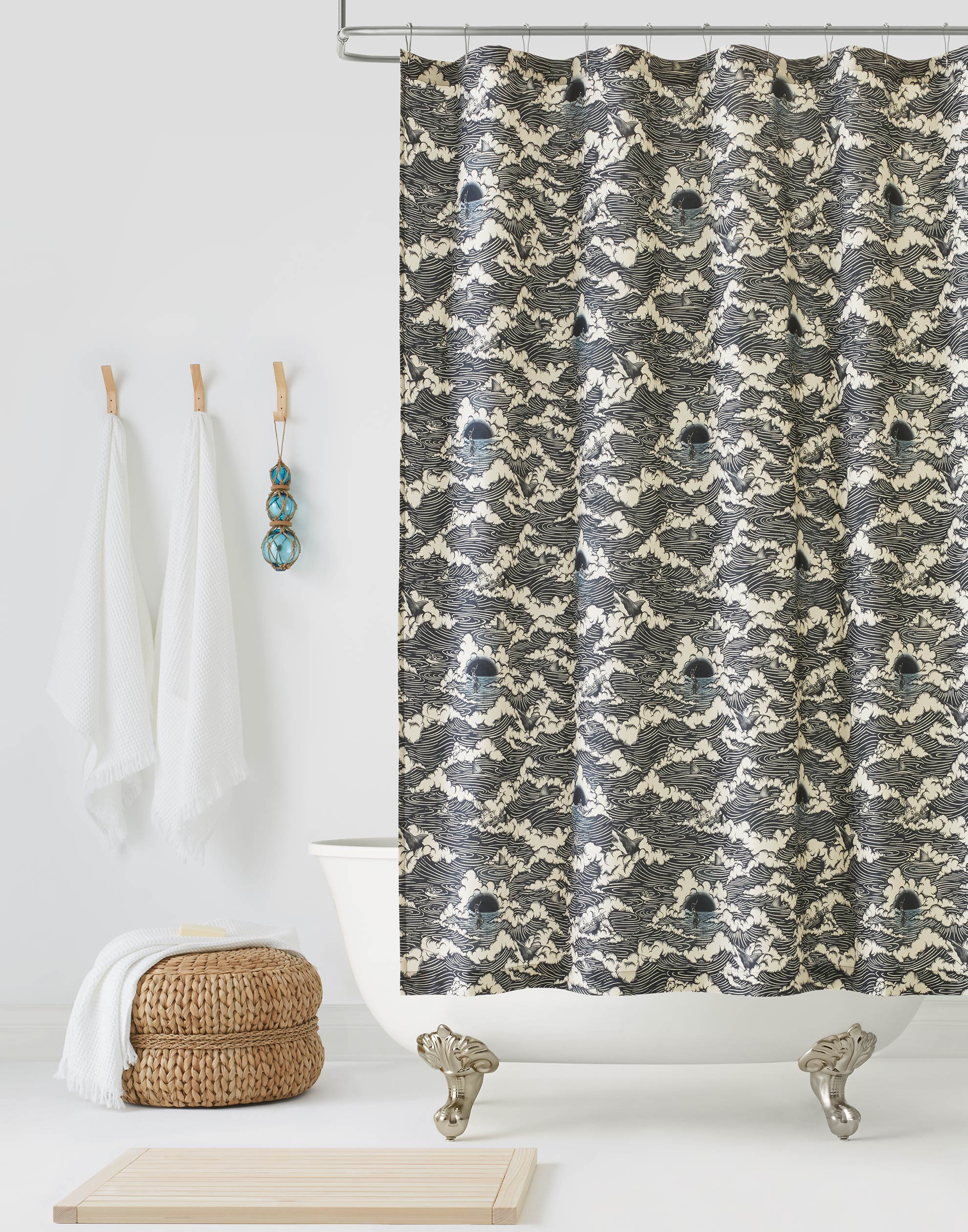 Amity Sunset (Ink) Shower Curtain with dark blue and cream illustrations depicts scenes from the iconic movie Jaws and was created in collaboration with Universal | Hygge & West
