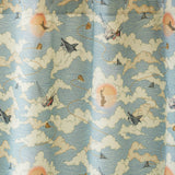 Amity Sunset (Sky) Shower Curtain with dusty blue, orange, and cream illustrations depicts scenes from the iconic movie Jaws and was created in collaboration with Universal | Hygge & West