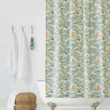 Amity Sunset (Sky) Shower Curtain with dusty blue, orange, and cream illustrations depicts scenes from the iconic movie Jaws and was created in collaboration with Universal | Hygge & West