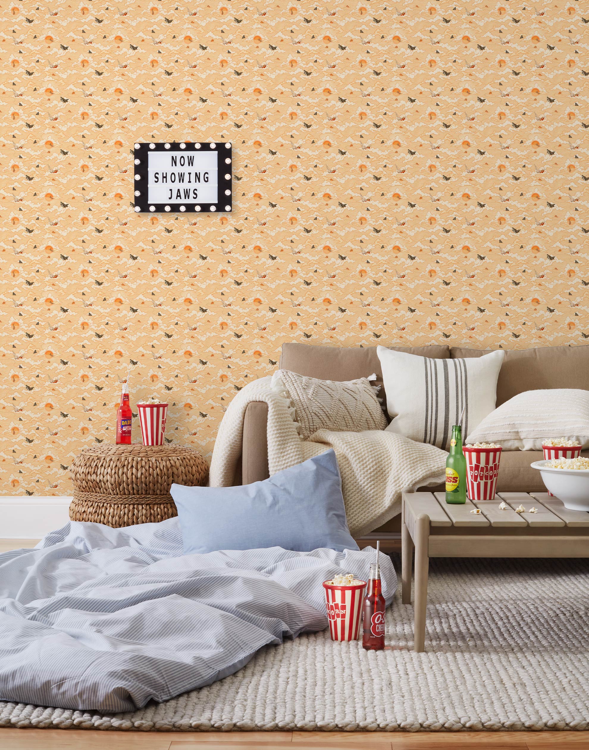 Amity Sunset (Blush) Wallpaper with pink, orange, and white illustrations depicts scenes from the iconic movie Jaws and was created in collaboration with Universal | Hygge & West